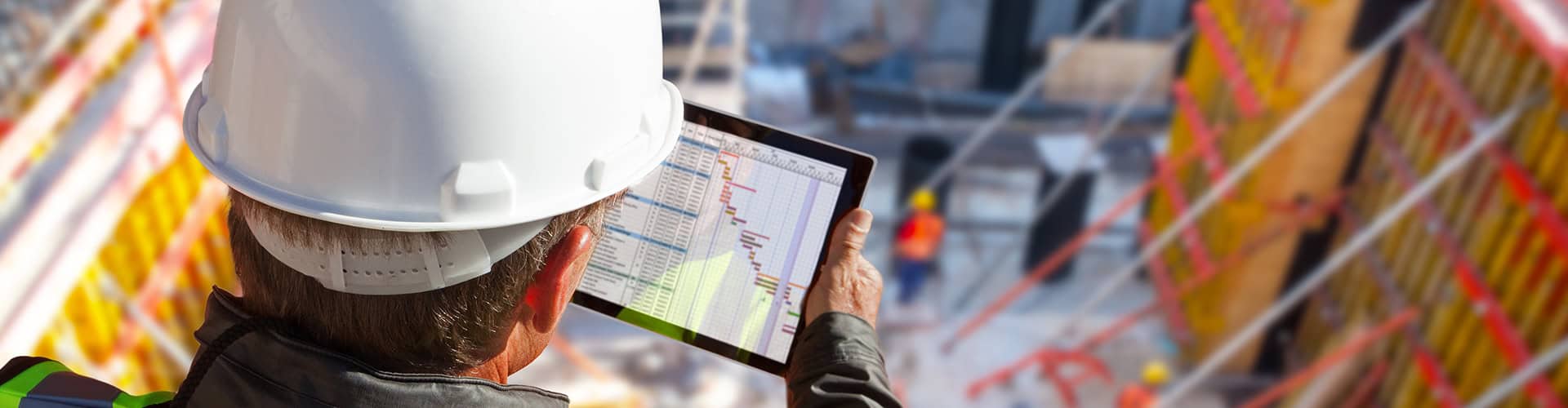Construction manager reviewing job logs on tablet for Renovo Construction