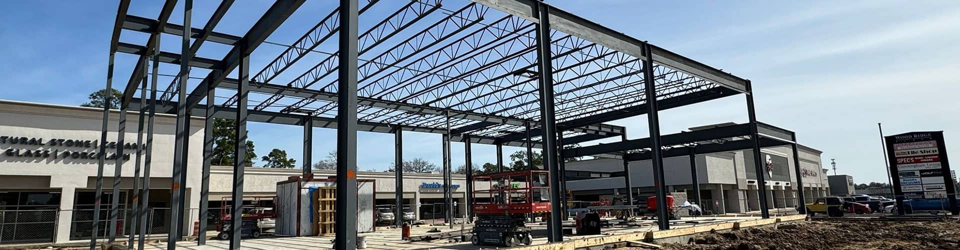 Building under construction by Renovo construction showing the slab and the framing in an open air mall