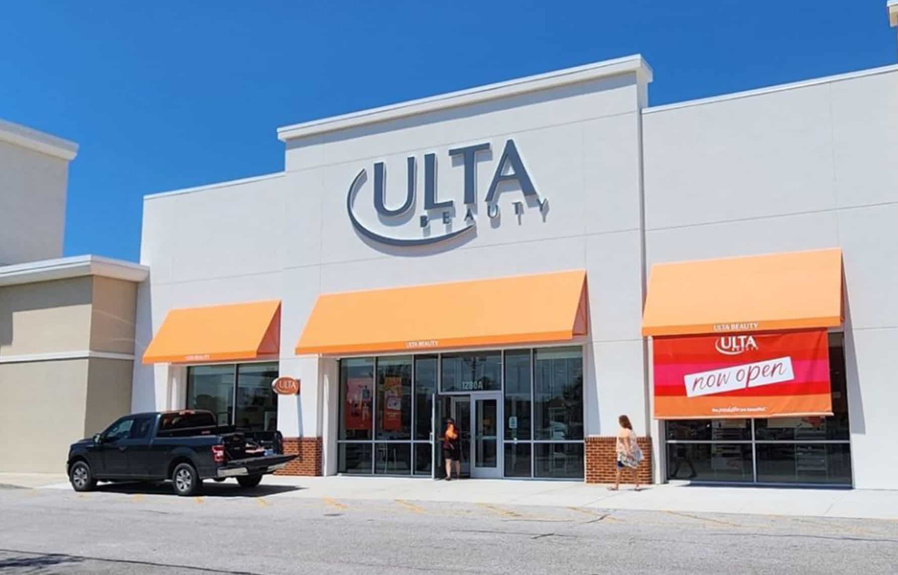 Ulta Beauty storefront showing peach awnings, signage, and bright orange pink and peach 
