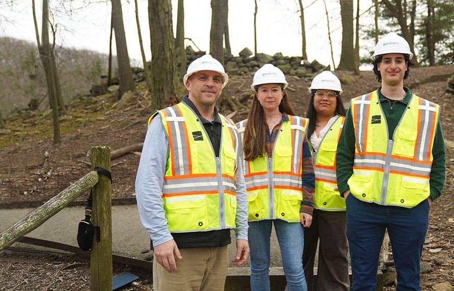 Renovo team members in branded hard hats and yellow PPE vests